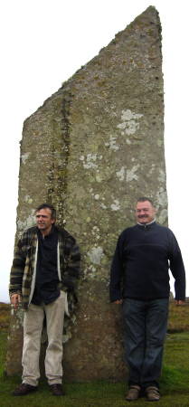 Kevin and Ray sheltering behind one of the Standing Stones of Brodgar